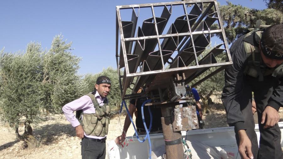 Free Syrian Army fighters stand next to a homemade rocket launcher in Sermeen near Idlib. DIY weapons of Syria,Syria DIY weapons,Syrian tanks,Syrian missiles,Syrian mortars,Dahiyat al-Assad