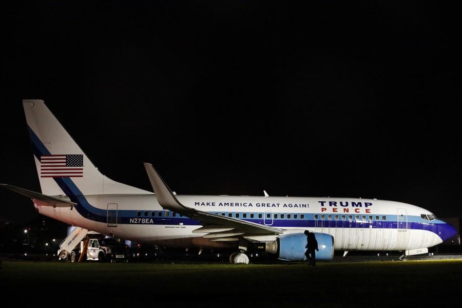A man walks past a campaign plane that had been carrying U.S. Republican vice presidential nominee Mike Pence as it rests in the grass after it skidded off the runway while landing in the rain at LaGuardia Airport in New York, U.S. Mike Pence skids,Mike Pence,Mike Pence skids off runway,Mike Pence off runway,LaGuardia Airport,LaGuardia airport