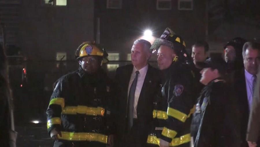 U.S. Republican vice presidential nominee Mike Pence poses for a photo with firefighters after a plane carrying him skidded off the runway after landing in the rain at New York City's LaGuardia Airport on Thursday, in this still image taken from video October 27, 2016. Mike Pence skids,Mike Pence,Mike Pence skids off runway,Mike Pence off runway,LaGuardia Airport,LaGuardia airport