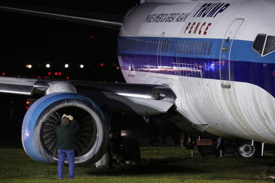 A man takes a photographs as he inspects a campaign plane that had been carrying U.S. Republican vice presidential nominee Mike Pence after it skidded off the runway while landing in the rain at LaGuardia Airport in New York, U.S. Mike Pence skids,Mike Pence,Mike Pence skids off runway,Mike Pence off runway,LaGuardia Airport,LaGuardia airport