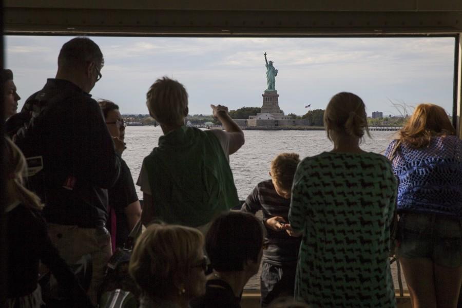People point at the Statue of Liberty as they ride the Staten Island Ferry. Statue of Liberty,statue of liberty in New York,Statue of Liberty turns 130,Statue of Liberty turns 130 years,Statue of Liberty pics,Statue of Liberty images,Statue of Liberty photos,Statue of Liberty pics stills,Statue of Liberty pics pictures