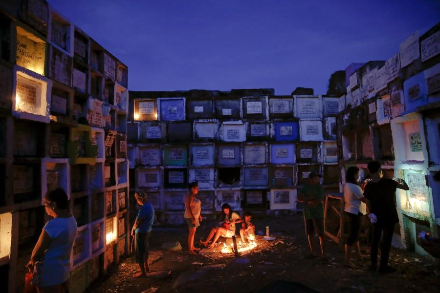 People visit tombs of their loved ones at Navotas Public cemetery in Manila, Philippines. All Saints' Day celebrations,All Saints Day,All Saints Day 2016,All Saints' Day 2016,All Saints' Day quotes,All Saints' Day wishes,All Saints' Day greetings,All Souls' day