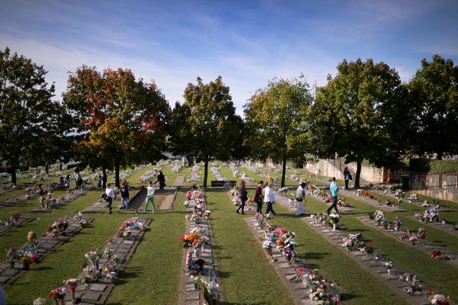 People walk past graves at Derio cemetery near Bilbao, Spain. All Saints' Day celebrations,All Saints Day,All Saints Day 2016,All Saints' Day 2016,All Saints' Day quotes,All Saints' Day wishes,All Saints' Day greetings,All Souls' day