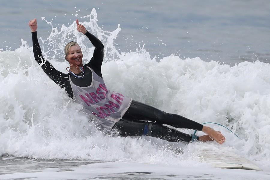 Karen Stuhr, 46, wears a Nasty Woman t-shirt and a mask of Hillary Clinton as she competes during the Haunted Heats Halloween Surf Contest in Santa Monica, California. Halloween surf contest,Halloween surf contest 2016,Halloween meets surfing,Santa Monica,Haunted Heats Halloween Surf Contest