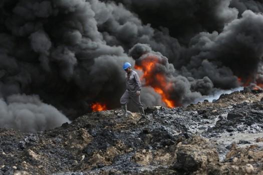 Smoke rises from oil wells, set ablaze by Islamic State militants before fleeing the oil-producing region of Qayyara.