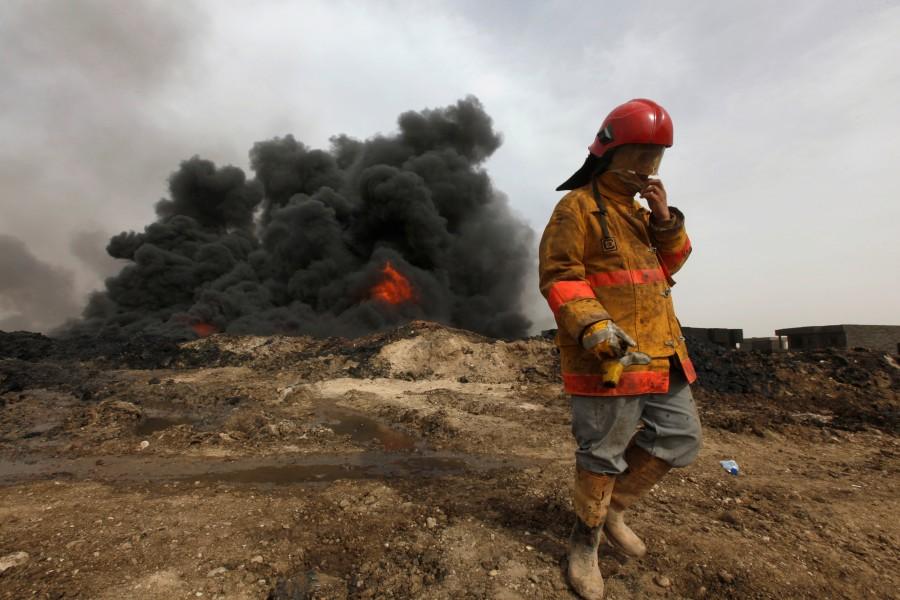 Smoke rises from oil wells, set ablaze by Islamic State militants before fleeing the oil-producing region of Qayyara. Black skies of Mosul,Islamic State,Apocalyptic scenes,Black oil,Battle for Mosul,ISIS