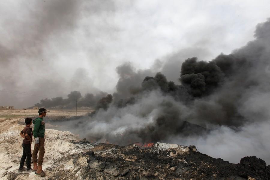 Smoke rises from oil wells, set ablaze by Islamic State militants before fleeing the oil-producing region of Qayyara. Black skies of Mosul,Islamic State,Apocalyptic scenes,Black oil,Battle for Mosul,ISIS