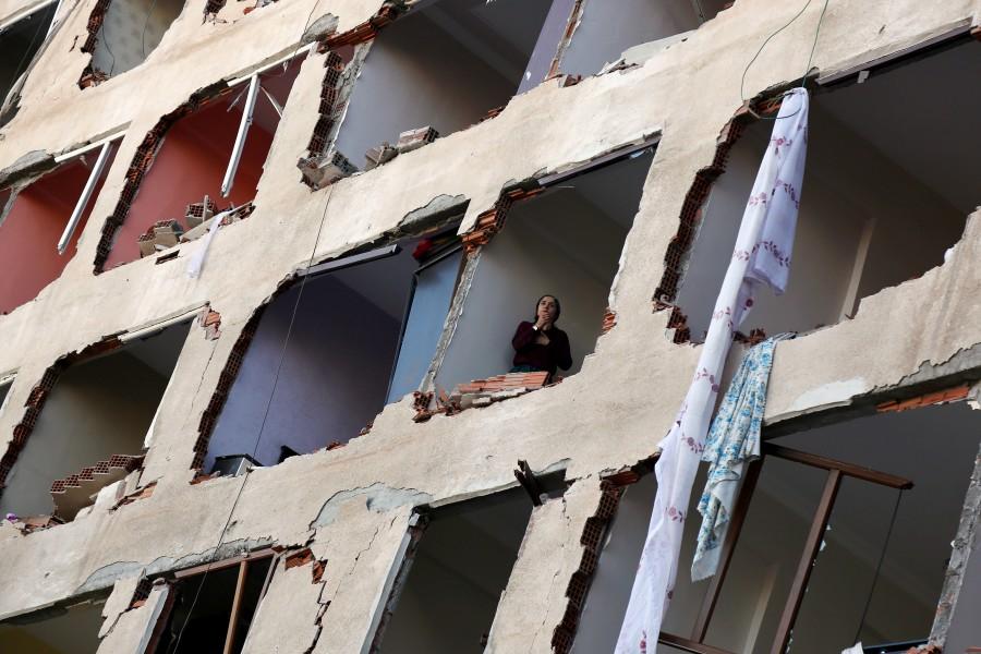 A woman looks out from a damaged building after a blast in the Kurdish-dominated southeastern city of Diyarbakir, Turkey. Car bomb,Car bomb explodes after Turkey detains,Car bomb explodes in Turkey,pro-Kurdish lawmakers,Turkey,blast in Diyarbakir,Diyarbakir blast
