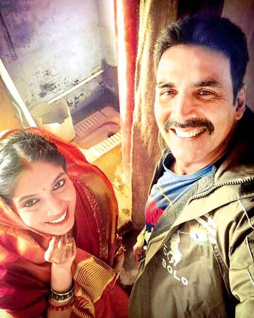 Akshay on Sunday took to Twitter, where he shared a photograph of himself with Bhumi. In the image, Bhumi is seen donning a red sari and vermillion on her forehead and Akshay is seen sporting a moustache. The two are seen posing in front of a toilet. "A very good morning from Bhumi Pednekar and me from the sets of 'Toilet: Ek Prem Katha' First day it is...need your best wishes," Akshay tweeted on Sunday. Akshay Kumar,Bhumi Pednekar,Toilet: Ek Prem Katha,Bollywood movie Toilet: Ek Prem Katha,Toilet: Ek Prem Katha shooting,Toilet: Ek Prem Katha first look,Toilet: Ek Prem Katha selfie,Akshay Kumar and Bhumi Pednekar