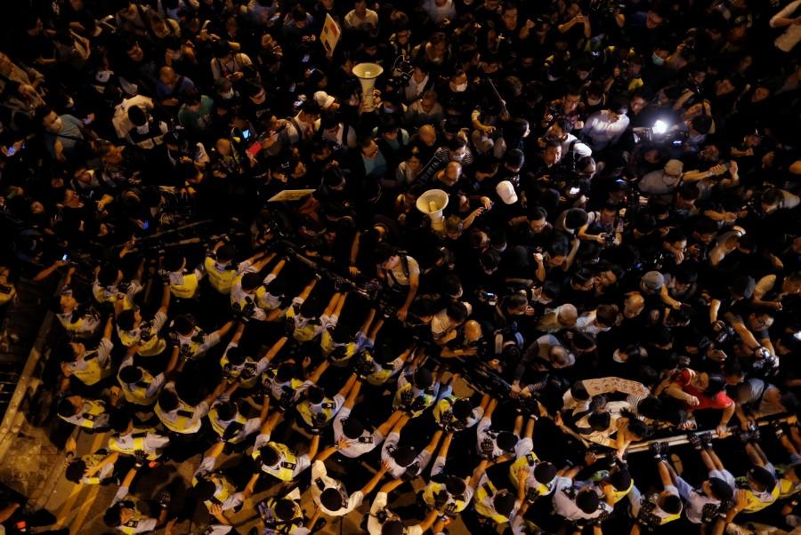 Police stop demonstrators as they protest against what they call Beijing's interference over local politics and the rule of law, a day before China's parliament is expected to announce their interpretation of the Basic Law in light of two pro-independence lawmakers' oath-taking controversy in Hong Kong. Anti-China march,Anti-China march in Hong Kong,China,China parliament,Beijing,Hong Kong pro-independence