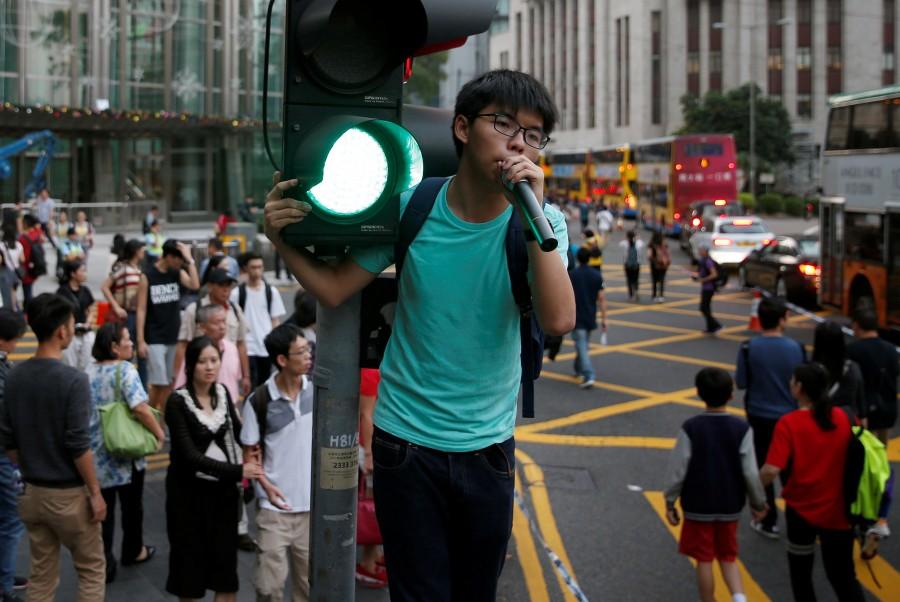 Pro-democracy activist Joshua Wong shouts during a protest against what they call Beijing's interference over local politics and the rule of law a day before China's parliament is expected to announce their interpretation of the Basic Law in light of two pro independence lawmakers' oath-taking controversy in Hong Kong. Anti-China march,Anti-China march in Hong Kong,China,China parliament,Beijing,Hong Kong pro-independence