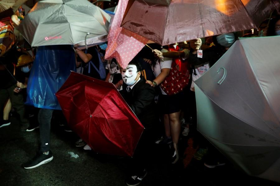 A protester wears Guy Fawkes mask during a confrontation with the police outside China Liaison Office in Hong Kong. Anti-China march,Anti-China march in Hong Kong,China,China parliament,Beijing,Hong Kong pro-independence