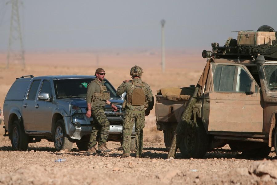 U.S. fighters stand near military vehicles, north of Raqqa city, Syria November 6, 2016. The operation by the Syrian Democratic Forces (SDF), which includes the Syrian Kurdish YPG militia and some Arab groups, began on Saturday and aims to encircle and ultimately capture Raqqa. It should add to the pressure on IS as it faces a major assault on its Iraqi bastion of Mosul. U.S-backed Syrian,U.S,Islamic State,Raqqa,Islamic State militants