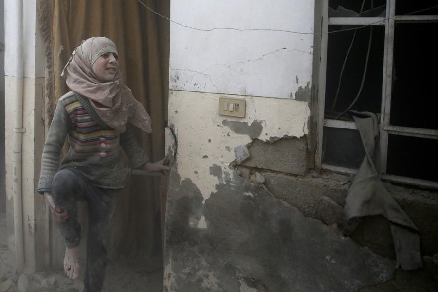 An injured girl reacts at a site hit by an airstrike in the rebel-held Douma neighbourhood of Damascus, Syria. Air strikes,Air strikes in Damascus,Damascus,Syrian army edges closer,Syrian army,Syrian Army tightens,Civil defence members,Syria