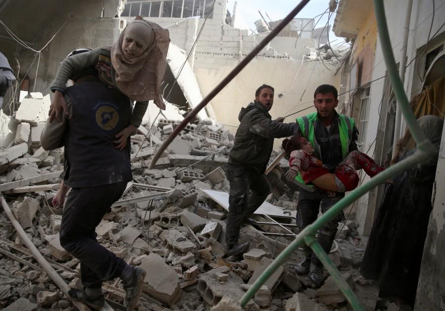 Civil defence members carry injured girls after an airstrike in the rebel-held Douma neighbourhood of Damascus, Syria. Air strikes,Air strikes in Damascus,Damascus,Syrian army edges closer,Syrian army,Syrian Army tightens,Civil defence members,Syria