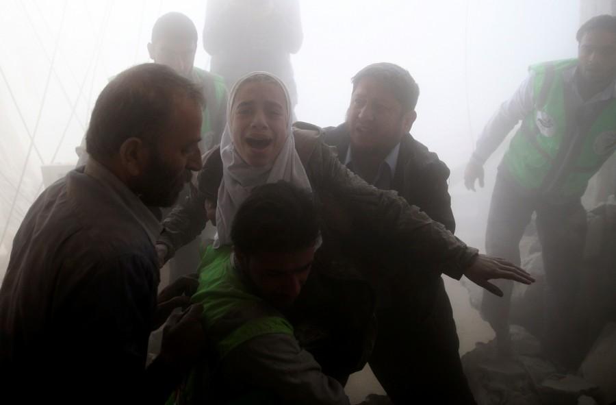 Men evacuate a girl from a site hit by an airstrike in the rebel-held Douma neighbourhood of Damascus, Syria. Air strikes,Air strikes in Damascus,Damascus,Syrian army edges closer,Syrian army,Syrian Army tightens,Civil defence members,Syria