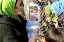 People see their relatives who had fled from Mosul at a fence surrounding Al-Khazer refugee camp, east of Mosul, Iraq.