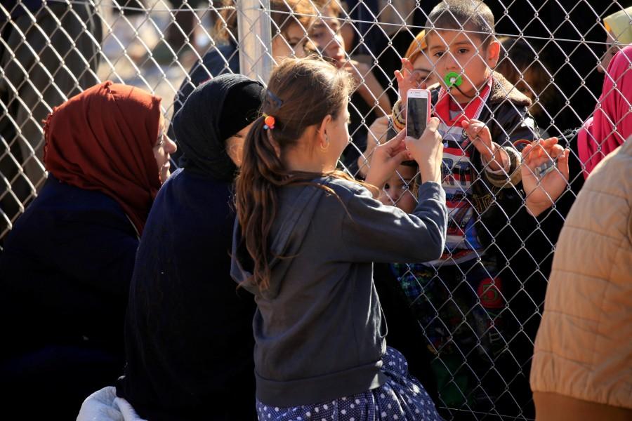 People stand at a fence surrounding a displacement camp to see their relatives who had fled from Mosul, at Al-Khazer refugee camp, east of Mosul, Iraq. Islamic State,Mosul,Mosul meet,Tearful reunions,Tearful reunions after escaping Islamic State,Mosul meet pics