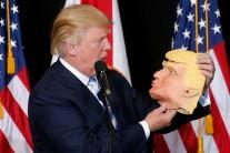 Donald Trump looks at a mask of himself as he speaks during a campaign rally in Sarasota, Florida.