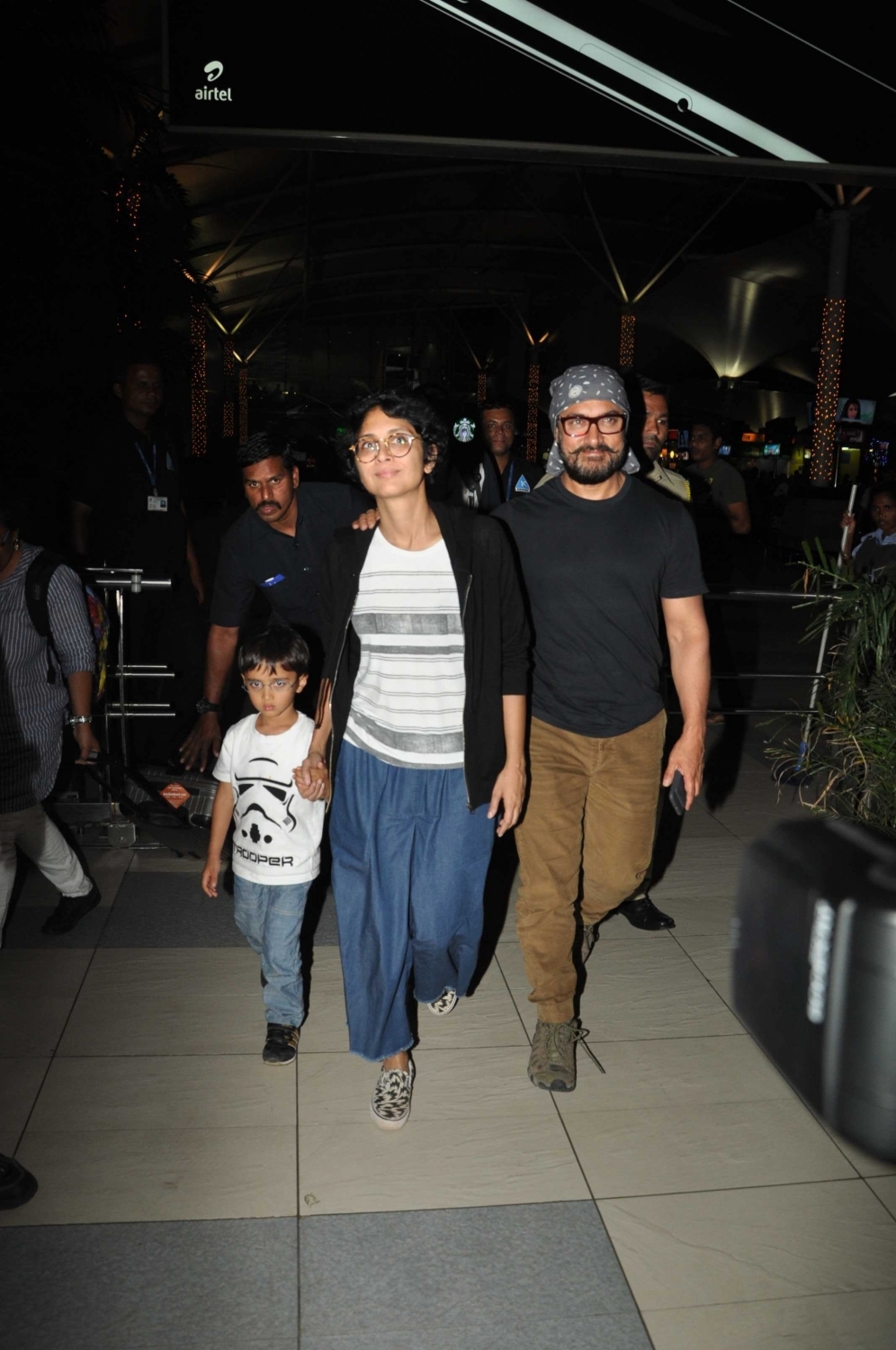 Photos of actor Aamir Khan with his wife Kiran Rao and son Azad Rao Khan spotted while returning from holiday in Mumbai. Aamir Khan,Kiran Rao,Azad Rao Khan,Aamir Khan & family returns from holidays,Aamir Khan spotted at Mumbai Airport,Aamir Khan wife Kiran Rao