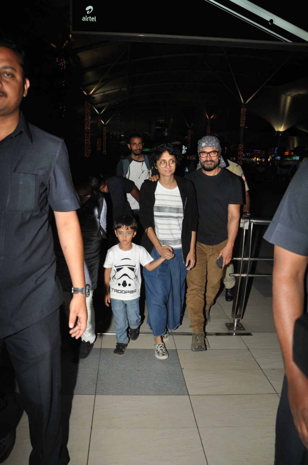 Photos of actor Aamir Khan with his wife Kiran Rao and son Azad Rao Khan spotted while returning from holiday in Mumbai. Aamir Khan,Kiran Rao,Azad Rao Khan,Aamir Khan & family returns from holidays,Aamir Khan spotted at Mumbai Airport,Aamir Khan wife Kiran Rao