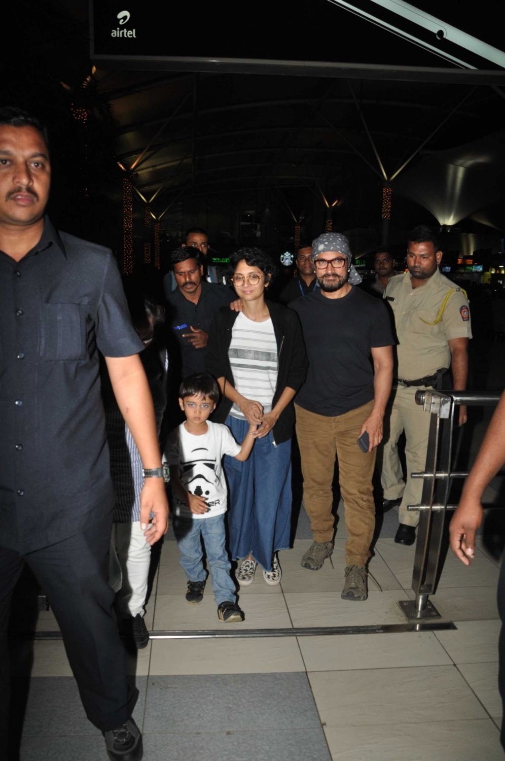 Photos of actor Aamir Khan with his wife Kiran Rao and son Azad Rao Khan spotted while returning from holiday in Mumbai. Aamir Khan,Kiran Rao,Azad Rao Khan,Aamir Khan & family returns from holidays,Aamir Khan spotted at Mumbai Airport,Aamir Khan wife Kiran Rao