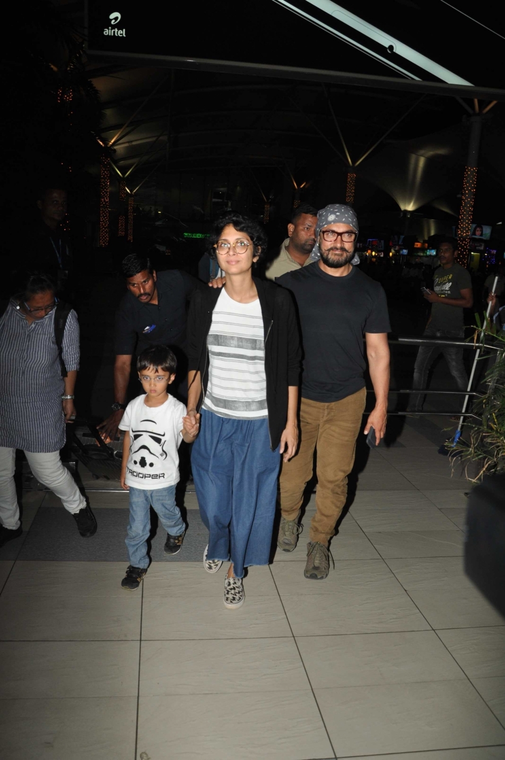 Photos of actor Aamir Khan with his wife Kiran Rao and son Azad Rao Khan spotted while returning from holiday in Mumbai. Aamir Khan,Kiran Rao,Azad Rao Khan,Aamir Khan & family returns from holidays,Aamir Khan spotted at Mumbai Airport,Aamir Khan wife Kiran Rao