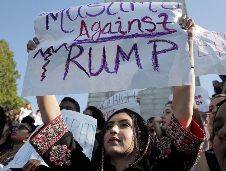 A young woman holds a sign while marching in protest to the election of Republican Donald Trump as President of the United States in Berkeley, California. Donald Trump,Donald Trump as 45th US President,45th US President,US President,America divided after the Election,People react after the results,America divided after election