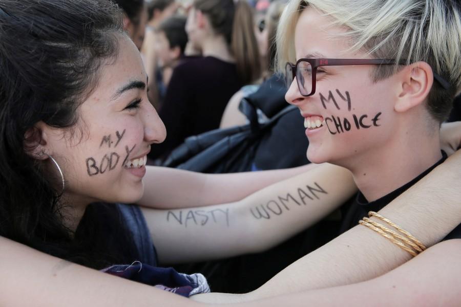 Tala Rahal, 14, left, and Ariana Echols, 14, right, both from Lowell High School, pose for a photo while attending a protest of the election in San Francisco, California. Anti-Trump protests,Trump protests,Donald Trump,Donald Trump protest,presidential election victory