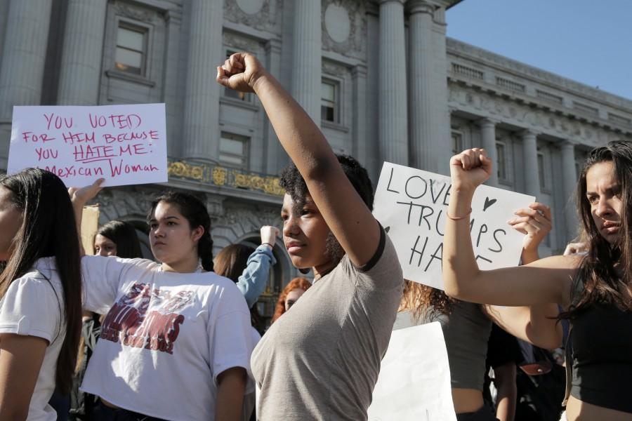 Leah Dobson, 17, of Drew School High School, center, raises her fist in protest of the election of Donald Trump in San Francisco, California. Anti-Trump protests,Trump protests,Donald Trump,Donald Trump protest,presidential election victory