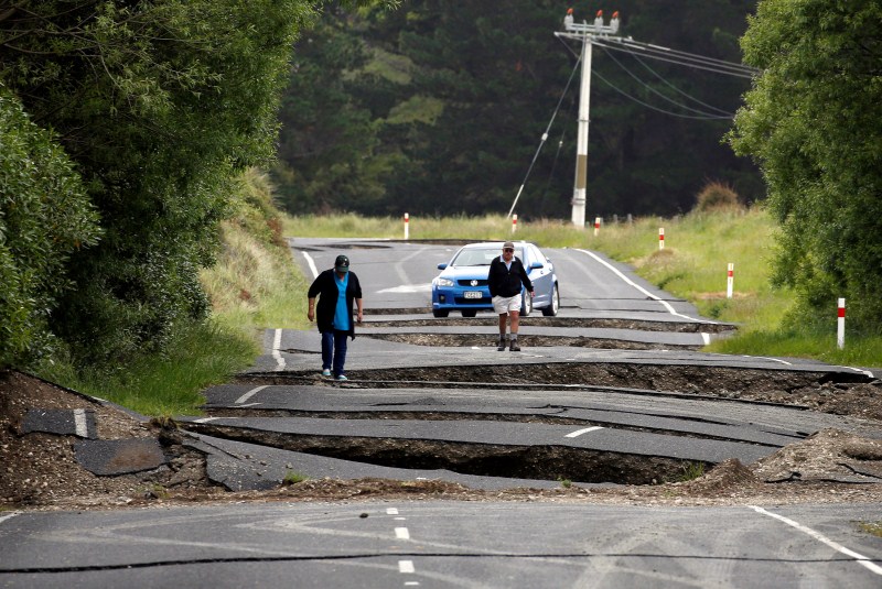 Local residents Chris and Viv Young look at damage caused by an earthquake along State Highway One near the town of Ward, south of Blenheim on New Zealand's South Island, November 14, 2016. New Zealand,New Zealand earthquake,New Zealand hit earthquake,New Zealand severe earthquake,New Zealand aftershocks