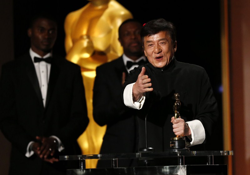 Actor Jackie Chan reacts as he accepts his Honorary Award as actor Chris Tucker (C) looks on at the 8th Annual Governors Awards in Los Angeles, California, U.S., November 12, 2016. Jackie Chan,Jackie Chan wins Oscar,Jackie Chan with Oscar,actor Jackie Chan,Jackie Chan Oscar,Jackie Chan at 8th Annual Governors Awards,8th Annual Governors Awards,8th Annual Governors Awards 2016