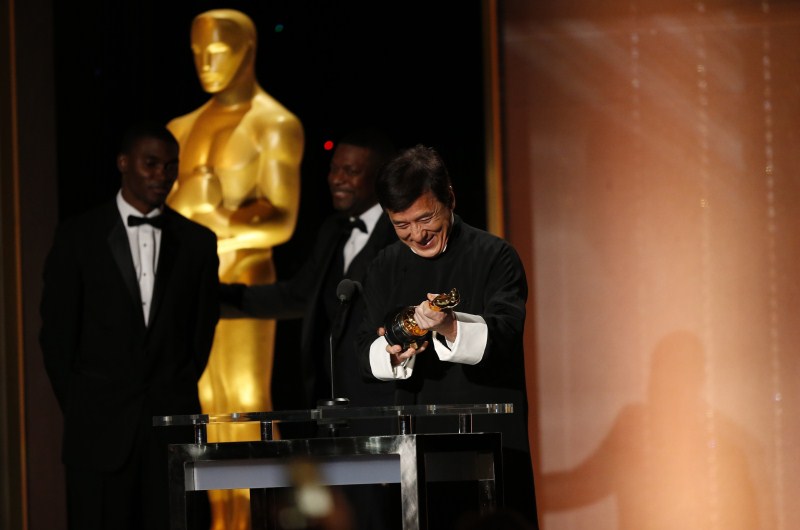 Actor Jackie Chan reacts as he accepts his Honorary Award as actor Chris Tucker (C) looks on at the 8th Annual Governors Awards in Los Angeles, California, U.S., November 12, 2016. Jackie Chan,Jackie Chan wins Oscar,Jackie Chan with Oscar,actor Jackie Chan,Jackie Chan Oscar,Jackie Chan at 8th Annual Governors Awards,8th Annual Governors Awards,8th Annual Governors Awards 2016