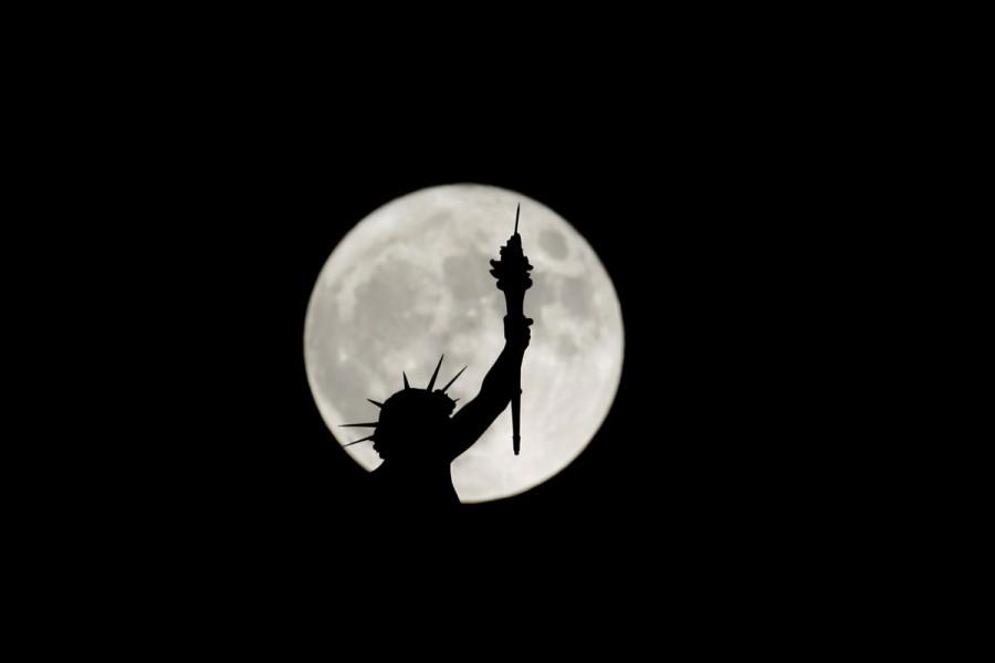 The rising supermoon is seen behind a statue on top of the Natural History Museum in Vienna, Austria. Supermoon,Supermoon around world,Supermoon in india,Supermoon pics,Supermoon images,Supermoon stills,Supermoon pictures,Supermoon photos,Supermoon new pics