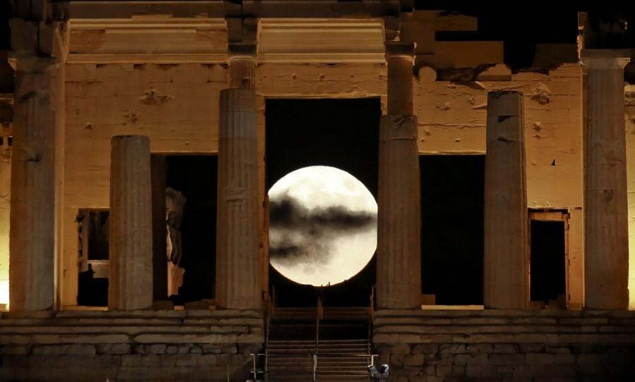 A rising "supermoon" is seen through the Propylaea, the ancient Acropolis hill gateway, in Athens, Greece. Supermoon,Supermoon around world,Supermoon in india,Supermoon pics,Supermoon images,Supermoon stills,Supermoon pictures,Supermoon photos,Supermoon new pics