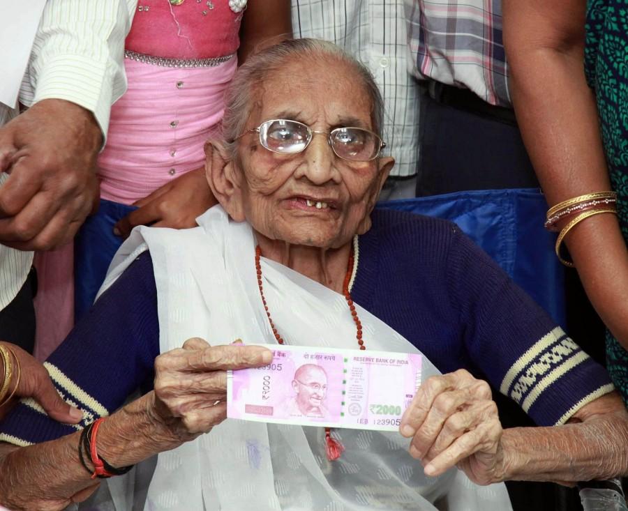 Photos of PM Narendra Modi's mother Heeraben Modi reaches a bank in Gandhinagar (Gujarat) to exchange currency. Narendra Modi,Narendra Modi mother,Narendra Modi mother Heeraben Modi,Heeraben Modi,Heeraben Modi visits bank,exchange currency