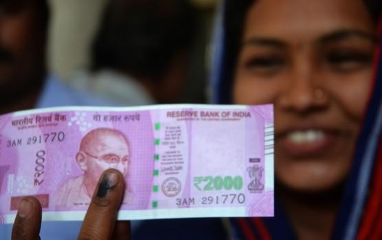 A woman gets her finger marked with indelible ink at a bank to exchange demonetised Rs 1000 and 500 notes in Bengaluru on Nov 16, 2016.