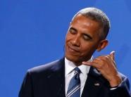 President Barack Obama gestures during a joint news conference with German Chancellor Angela Merkel in Berlin, Germany.