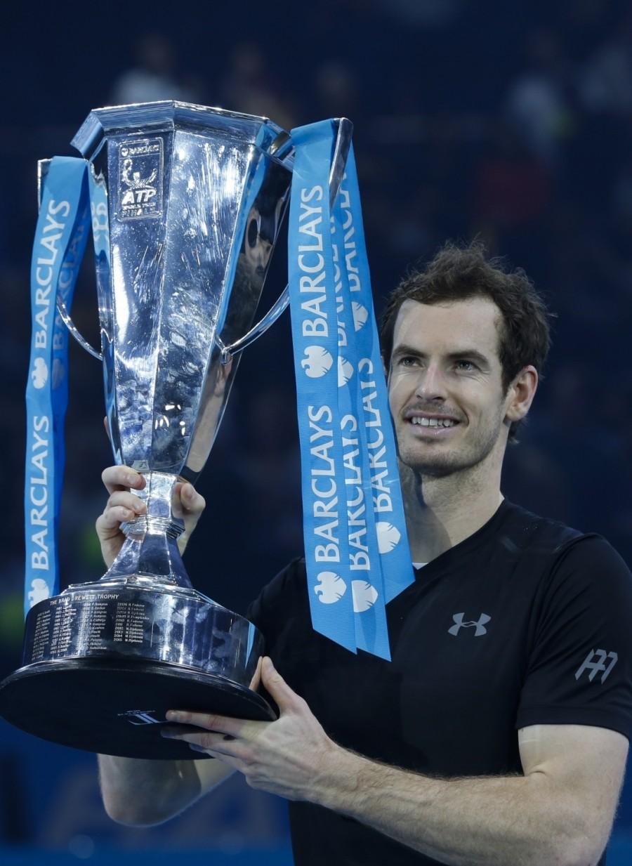 Andy Murray of Britain celebrates with the ATP World Tour Finals trophy after winning the men's singles final against Serbia's Novak Djokovic at the 2016 ATP World Tour Finals at the O2 Arena in London, Britain on Nov. 20, 2016. Murray won 2-0. Andy Murray,Novak Djokovic,Andy Murray beats Novak Djokovic,Andy Murray wins ATP World Tour Finals,Andy Murray wins ATP World Tour,Andy Murray wins ATP World Tour title,ATP World Tour Finals,ATP World Tour Finals 2016,ATP World Tour,ATP World Tour pics,AT