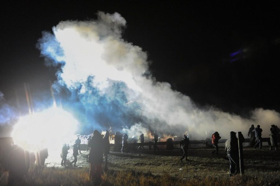 Police tear gas protesters during a protest against plans to pass the Dakota Access pipeline near the Standing Rock Indian Reservation, near Cannon Ball, North Dakota, U.S. November 20, 2016. North Dakota,North Dakota pipeline protest,Dakota Access oil pipeline project,Native American tribe,Native American