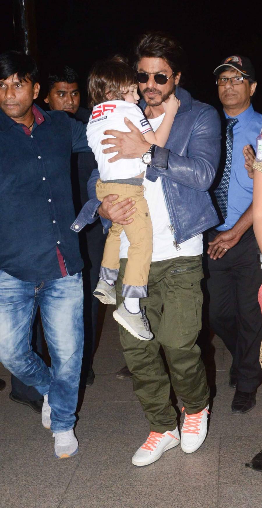 Photos of Bollywood actor Shahrukh Khan snapped with Abram at Mumbai Airport. Shahrukh Khan,Shahrukh Khan with Abram,Shahrukh Khan with Abram at Mumbai Airport,Shahrukh Khan at Mumbai Airport,Abram at Mumbai Airport,Abram,Shahrukh Khan and Abram