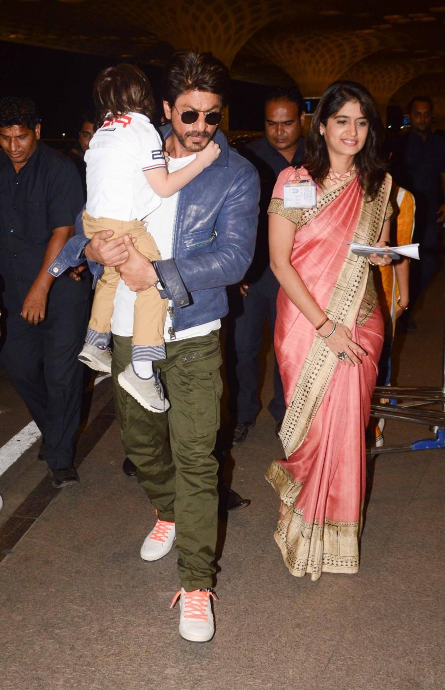 Photos of Bollywood actor Shahrukh Khan snapped with Abram at Mumbai Airport. Shahrukh Khan,Shahrukh Khan with Abram,Shahrukh Khan with Abram at Mumbai Airport,Shahrukh Khan at Mumbai Airport,Abram at Mumbai Airport,Abram,Shahrukh Khan and Abram