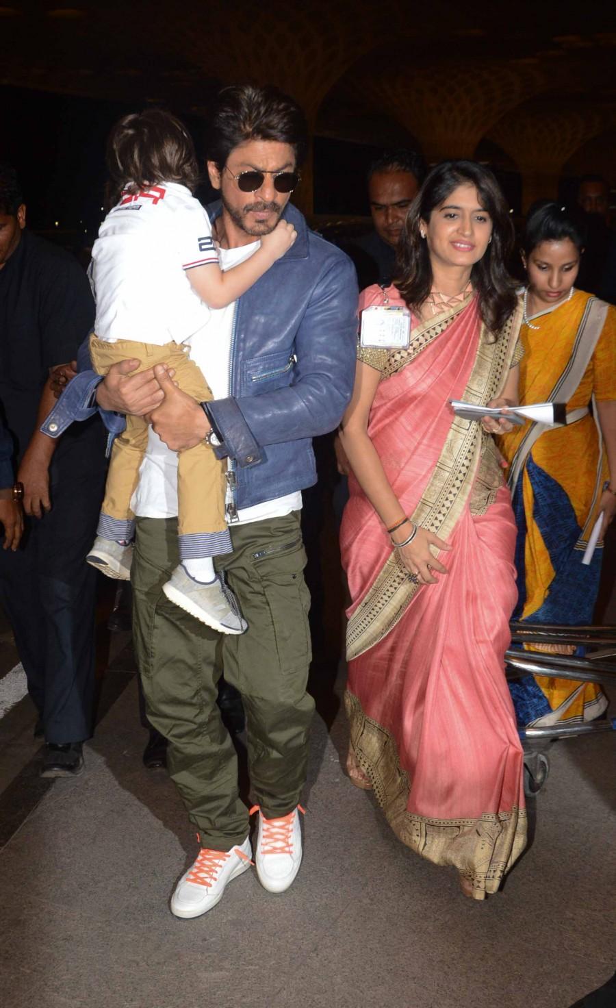 Photos of Bollywood actor Shahrukh Khan snapped with Abram at Mumbai Airport. Shahrukh Khan,Shahrukh Khan with Abram,Shahrukh Khan with Abram at Mumbai Airport,Shahrukh Khan at Mumbai Airport,Abram at Mumbai Airport,Abram,Shahrukh Khan and Abram