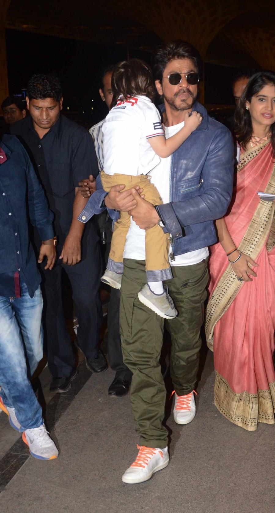 Photos of Bollywood actor Shahrukh Khan snapped with Abram at Mumbai Airport. Shahrukh Khan,Shahrukh Khan with Abram,Shahrukh Khan with Abram at Mumbai Airport,Shahrukh Khan at Mumbai Airport,Abram at Mumbai Airport,Abram,Shahrukh Khan and Abram