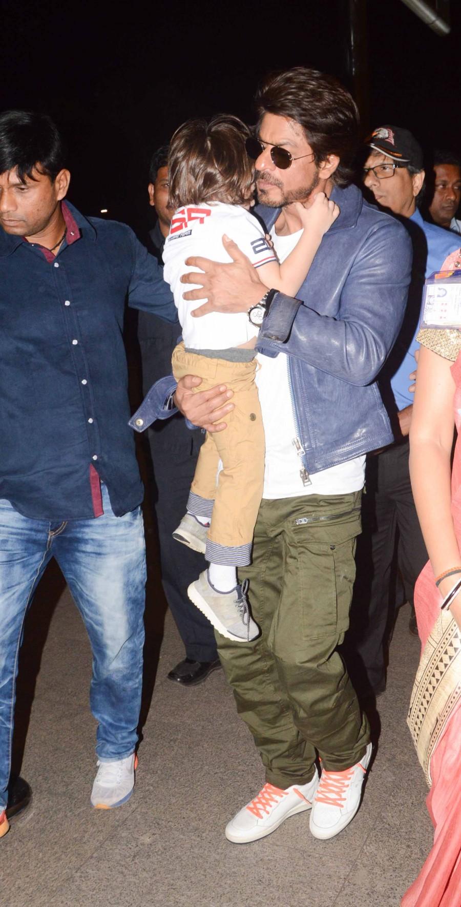 Photos of Bollywood actor Shahrukh Khan snapped with Abram at Mumbai Airport. Shahrukh Khan,Shahrukh Khan with Abram,Shahrukh Khan with Abram at Mumbai Airport,Shahrukh Khan at Mumbai Airport,Abram at Mumbai Airport,Abram,Shahrukh Khan and Abram