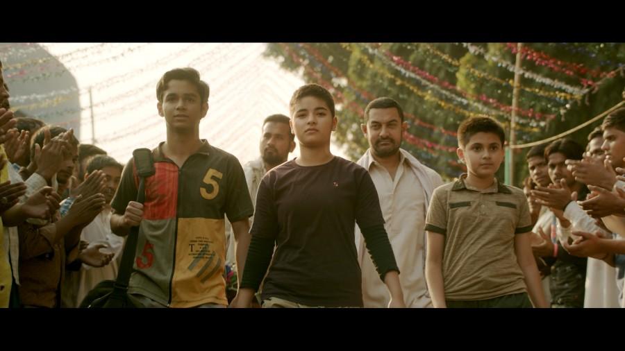 After Haanikaarak Bapu's fantastic reception, the makers of Dangal have released their second song titled Dhaakad and the song is all about woman power. Dhaakad means powerful, potential and the makers want to dedicate this song to the daughters of India. The song, showcases the young girls wrestling with heavily built men, winning a victory over them with immense ease. The first line being "निक्कर और टी सर्ट पहेन के आया सायकलोन". Dangal,Dangal songs,Dangal movie songs,Dhaakad,Dhaakad song,Aamir Khan