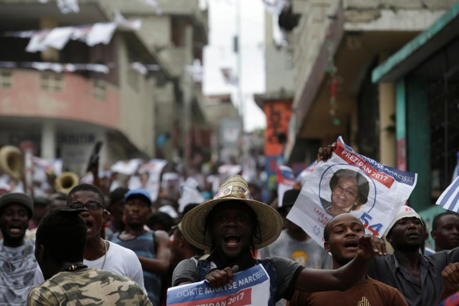 Supporters of Fanmi Lavalas political party march in the streets of Port-au-Prince, Haiti. With paper ballots counted laboriously by hand, election results typically take a week to be announced in Haiti. But less than 24 hours after polling centres had closed, some candidates and their supporters claimed they had won, leading to chaotic scenes in the capital where guards were forced to shoot into the air to clear a celebrating crowd. Tensions mount as Haiti,Haiti,Haiti relection,Haiti waits for election results,Haiti for election resultselection results,election results,Caribbean country