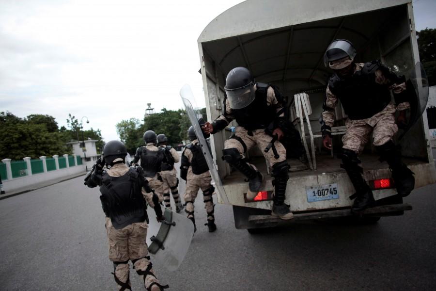 National Police officers deploy to disperse supporters of Fanmi Lavalas political party as they march next to the National Palace of Port-au-Prince, Haiti. The vote was first held in October 2015, but then annulled over complaints of fraud in the first round after Jovenel Moise, the candidate of former President Michel Martelly's Bald Heads Party, finished ahead of Jude Celestin, previously boss of a state construction company. Further disputes ensued and a fresh vote due last month was postponed when Hurricane Matthew struck. Tensions mount as Haiti,Haiti,Haiti relection,Haiti waits for election results,Haiti for election resultselection results,election results,Caribbean country