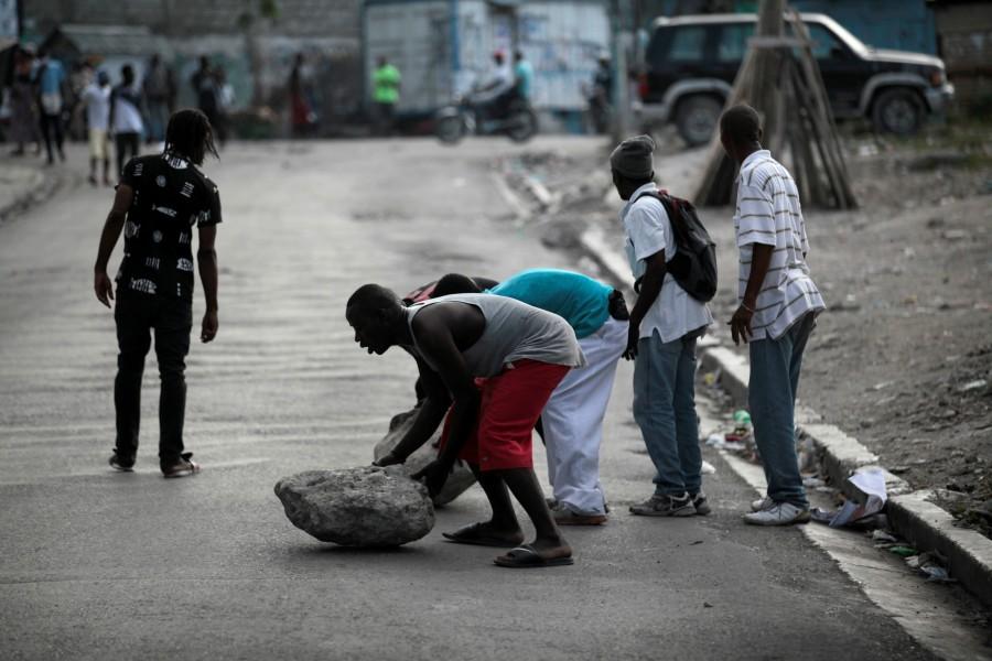 Supporters of Fanmi Lavalas political party block a street with rocks during a demonstration in Port-au-Prince, Haiti. Tensions mount as Haiti,Haiti,Haiti relection,Haiti waits for election results,Haiti for election resultselection results,election results,Caribbean country