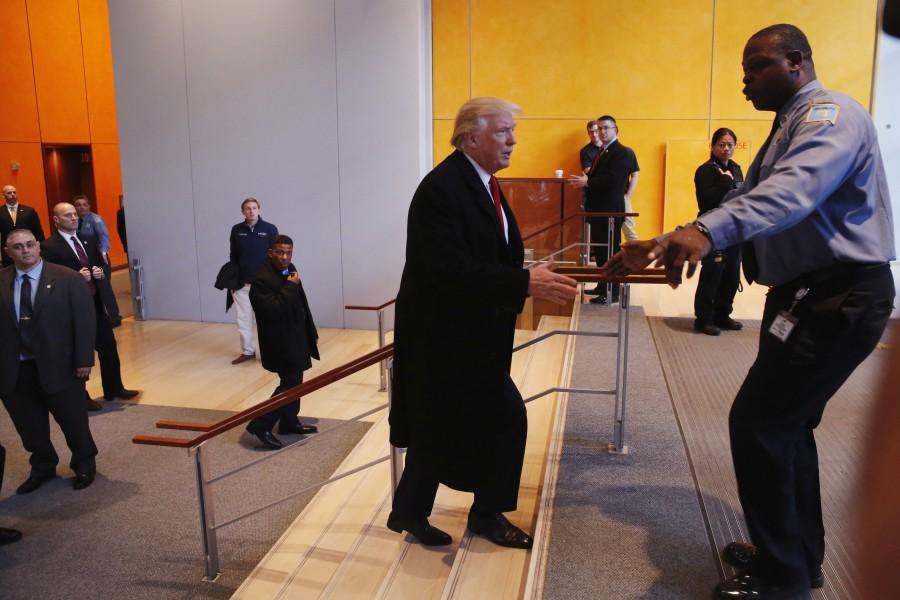 President-elect Donald Trump is stopped as he walks up a staircase in an attempt to depart the lobby of the New York Times building. Donald Trump,President-elect Donald Trump,Donald Trump meets New York Journalists,Donald Trump meets New York Journalists and executives,New York Journalists,New York Journalists and executives